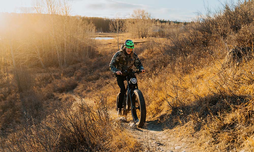a man is riding Brawn long range ebike outside