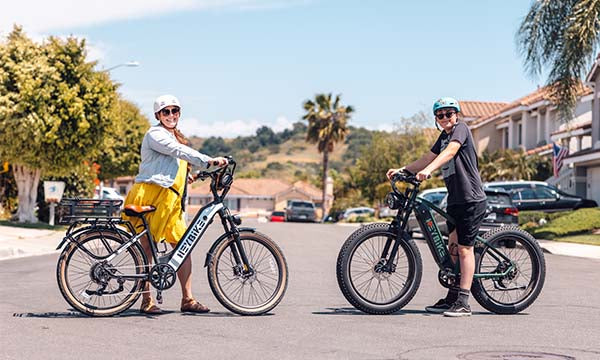 A woman and a boy are holding Heybike step-over and low-step e-bikes