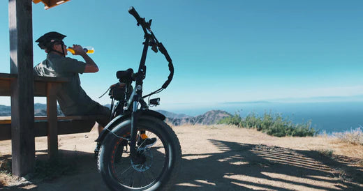 A man rides a Heybike e-bike and easily arrives at the top of the mountain.