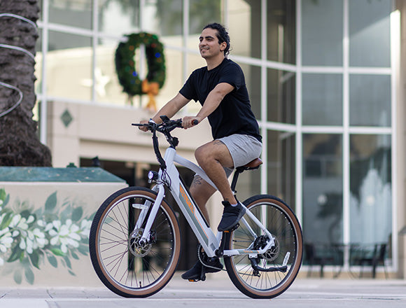 a man is riding his white Sola ebike